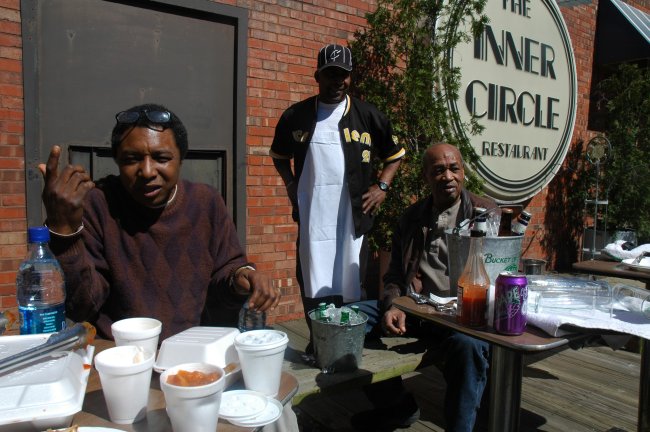 Greg and LeMaud Williams on the deck at the Inner Circle with a customer - a Hot Sauce Williams enterprise